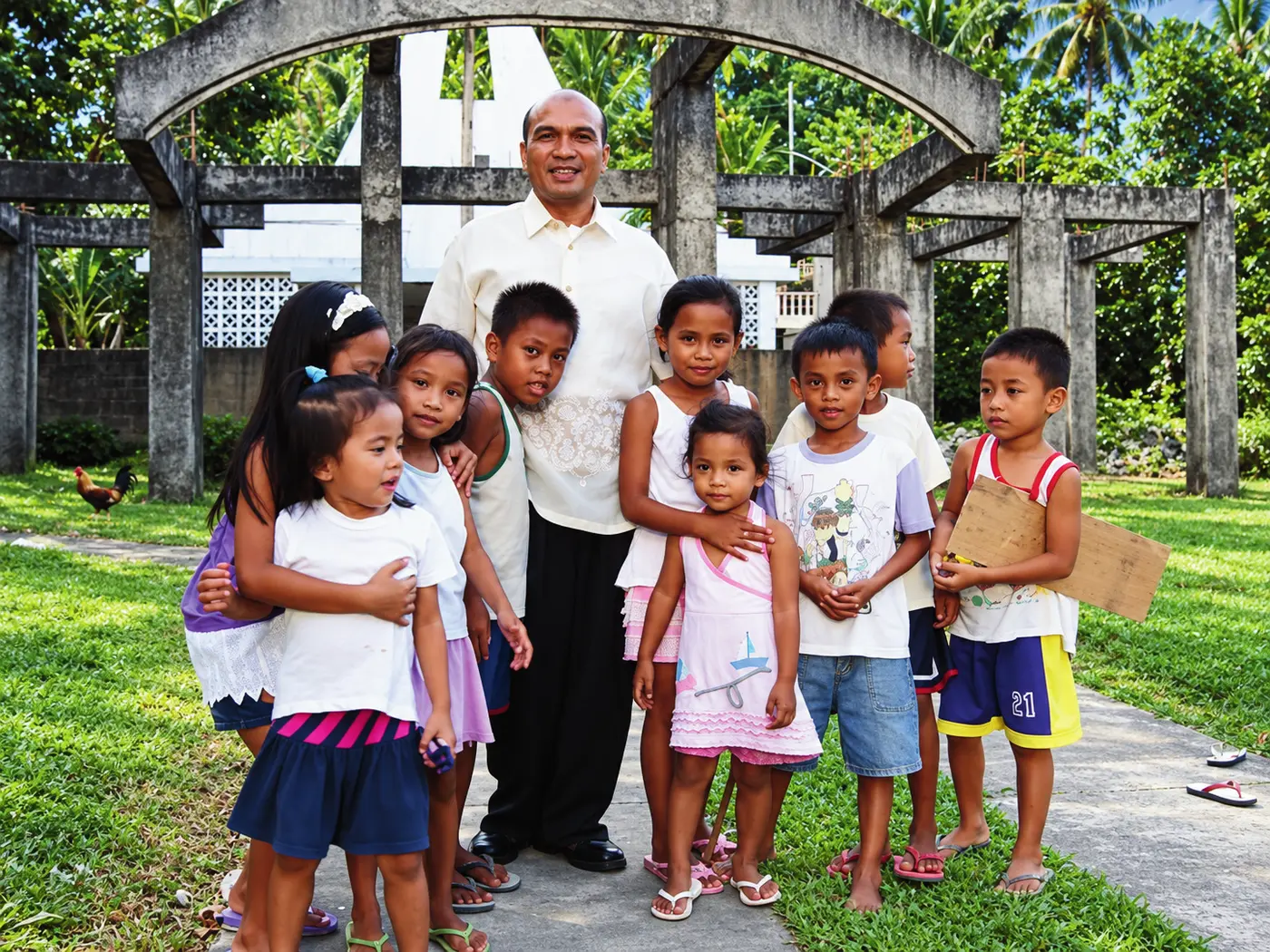 Manrico T. Masagca with children during a community activity